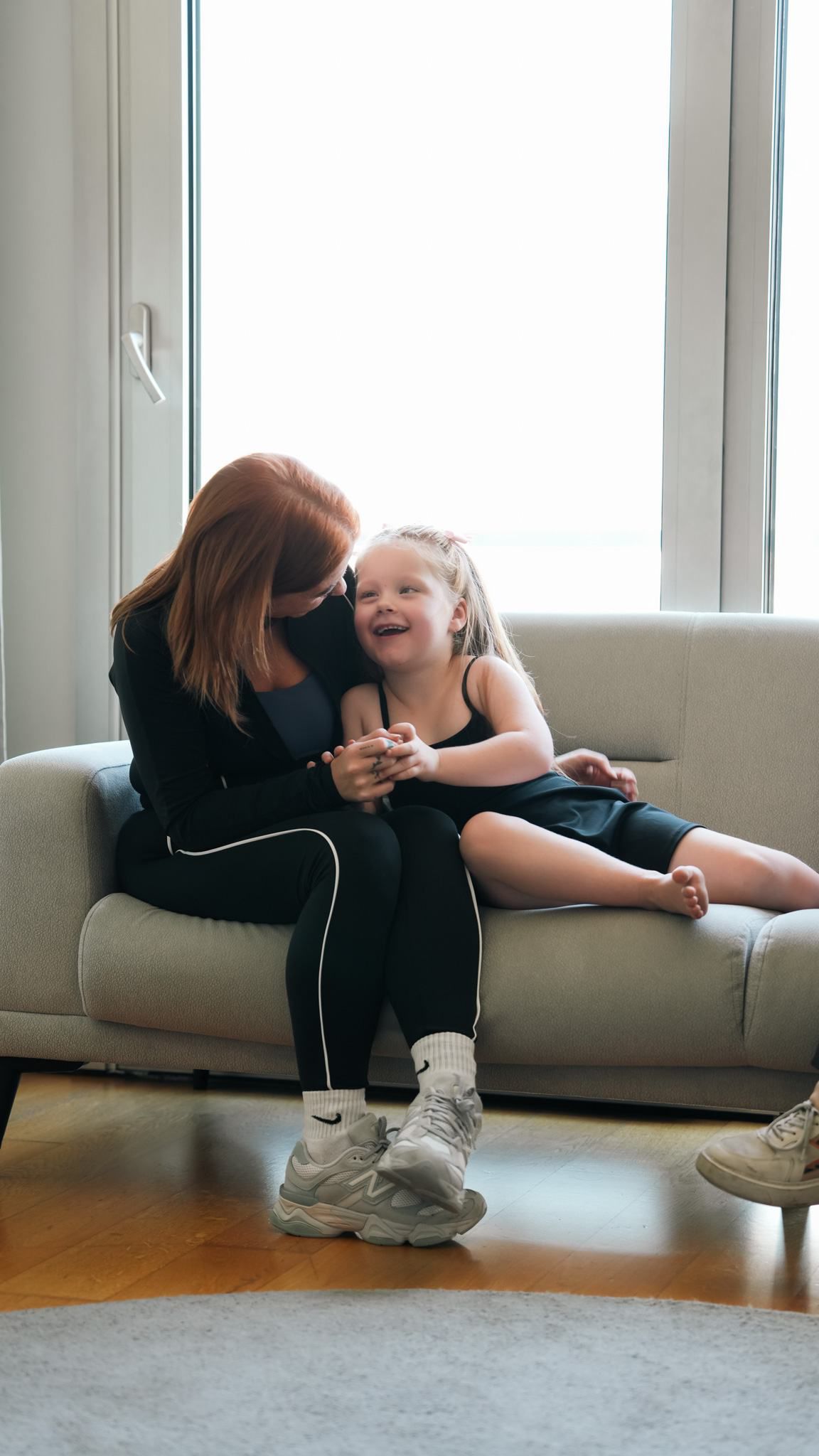A parent and child smiling together